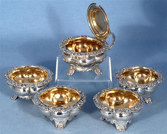 A set of four George III provincial silver table salts with matching mustard, Diameter 3 ¾”/94mm combined weight 21.5oz/609grm